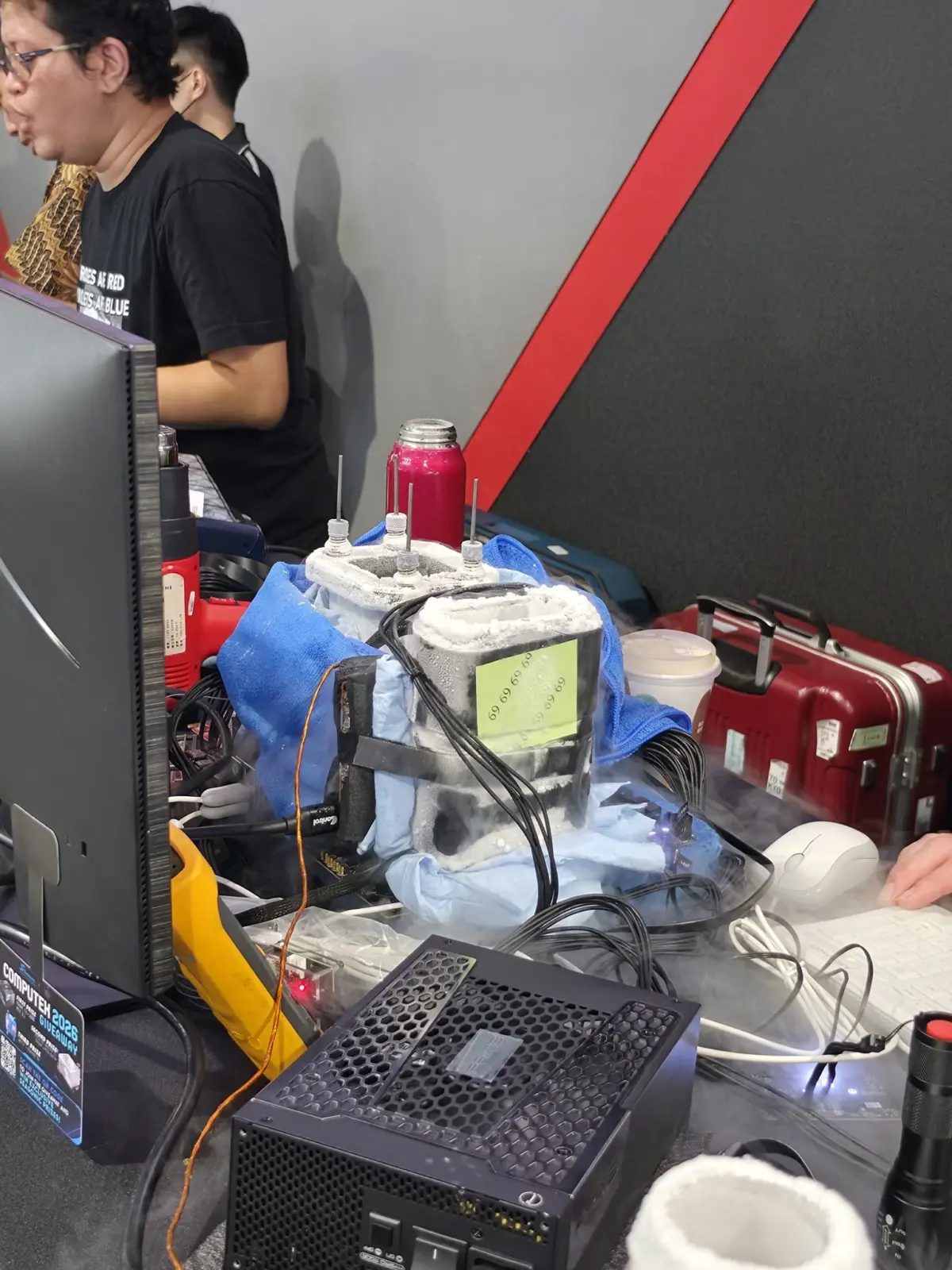 AMD Radeon RX 9060 XT graphics card on a test bench with liquid nitrogen cooling setup
