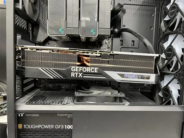 Gigabyte RTX 4090 GAMING graphics card resting on a motherboard