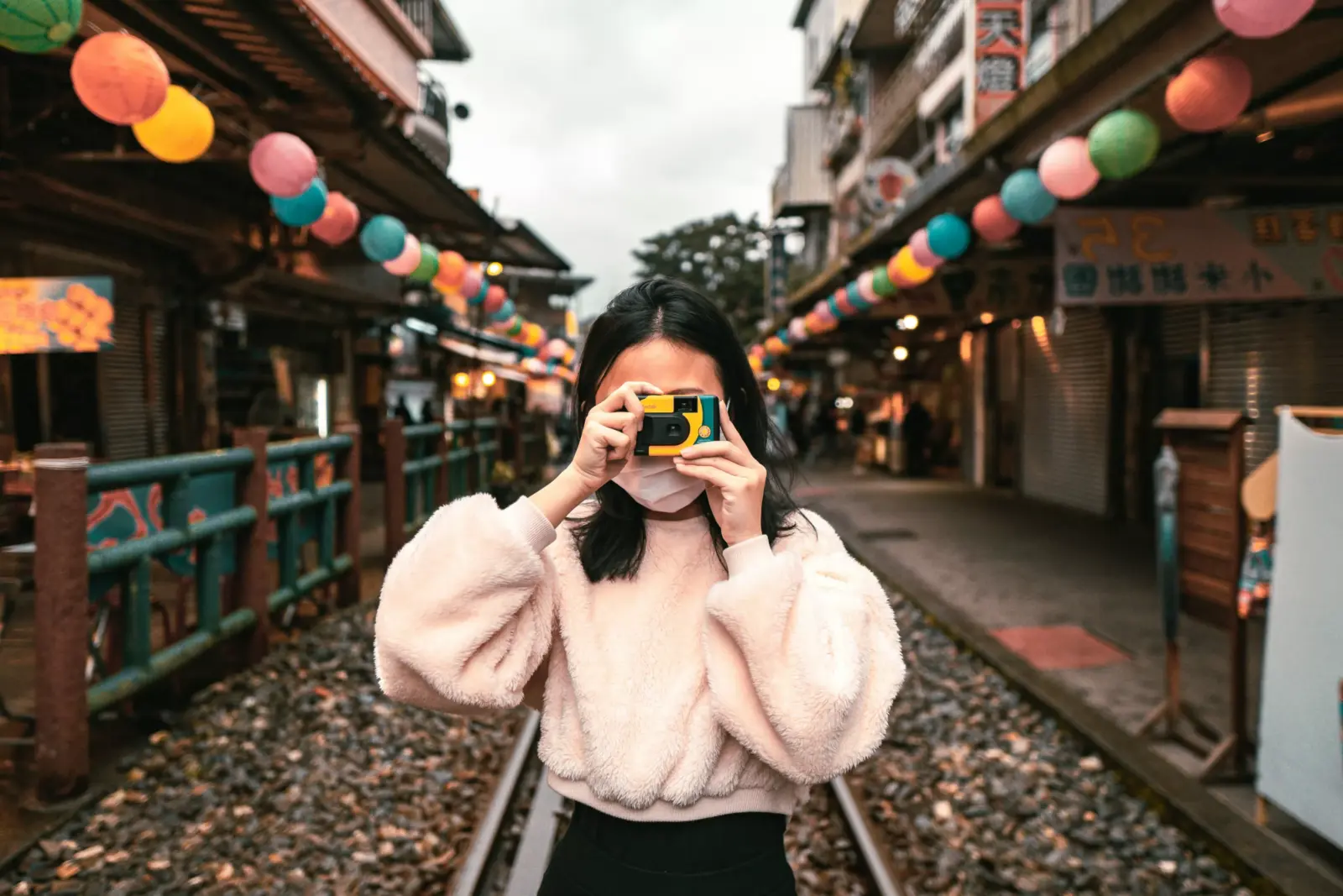 Young person using a film camera