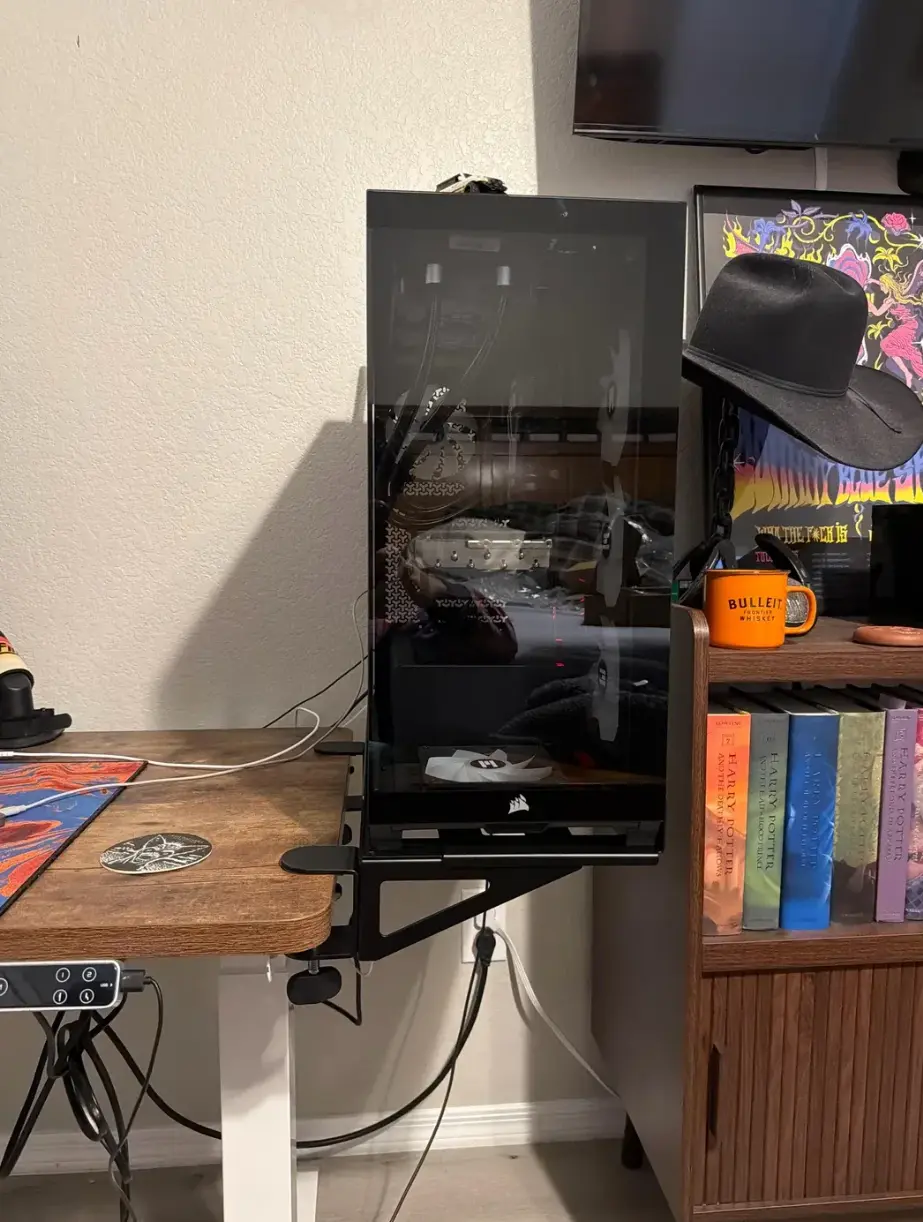 High-end gaming PC suspended from a desk clamp