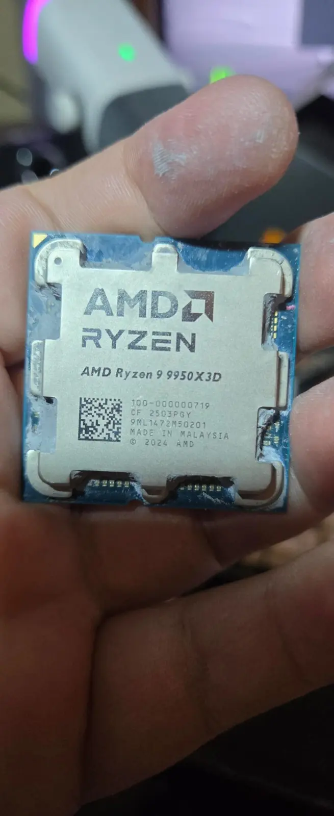 Damaged AMD Ryzen 9 9950X3D processor showing brown marks on the die