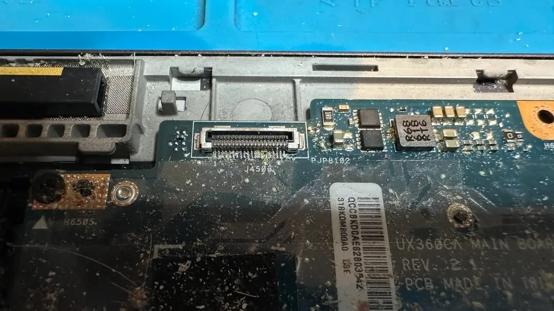 Laptop interior filled with food crumbs and residue
