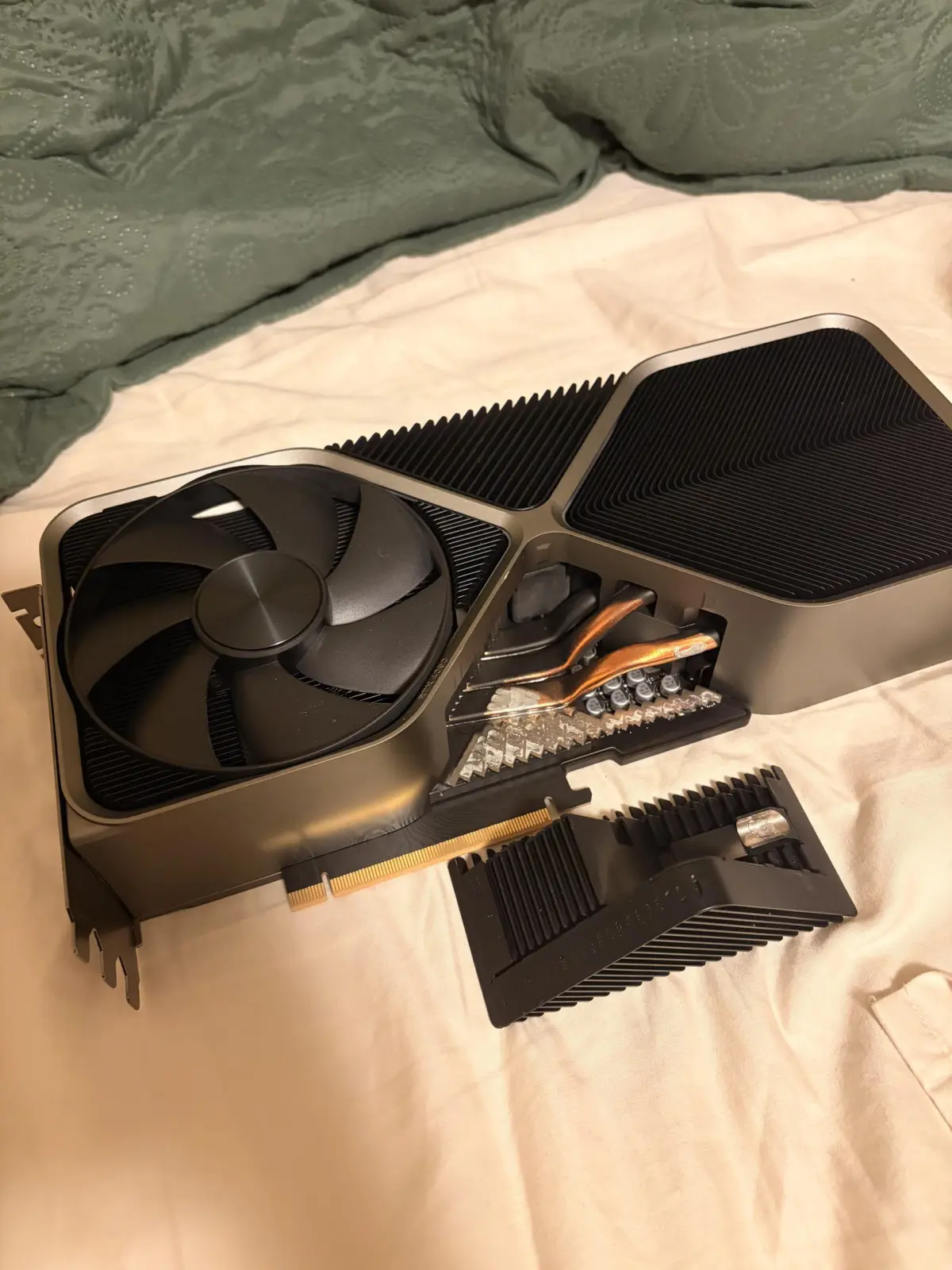Detached triangular heatsink piece from RTX 4090 Founders Edition exposing heat pipes